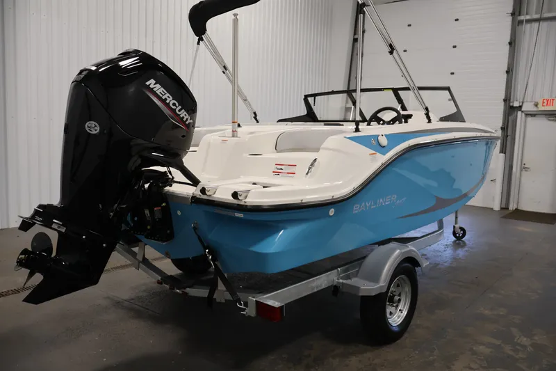 Slide: The Image of 2026 Bayliner Element M17 boat with Mercury outboard motor in a garage setting. - 4