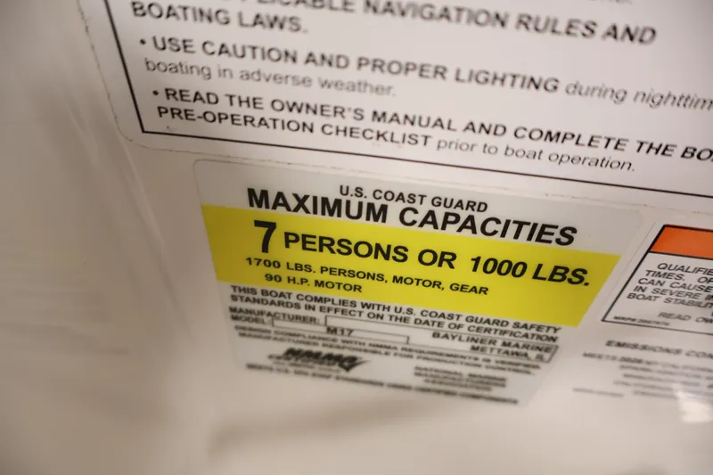 Slide: The Image of Bayliner Element M17 2026 capacity label: 7 persons or 1000 lbs, 90 HP motor. - 18