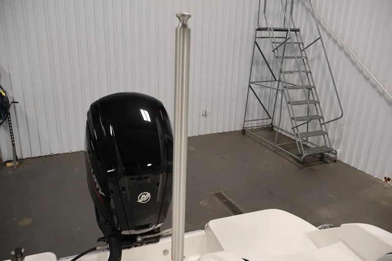 Slide: The Image of 2026 Bayliner Element M17 boat with Mercury outboard motor in a garage setting. - 22