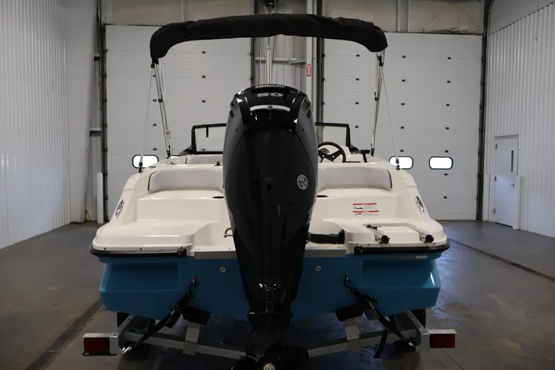 Slide: The Image of 2026 Bayliner Element M17 boat in a garage, rear view with outboard motor. - 5
