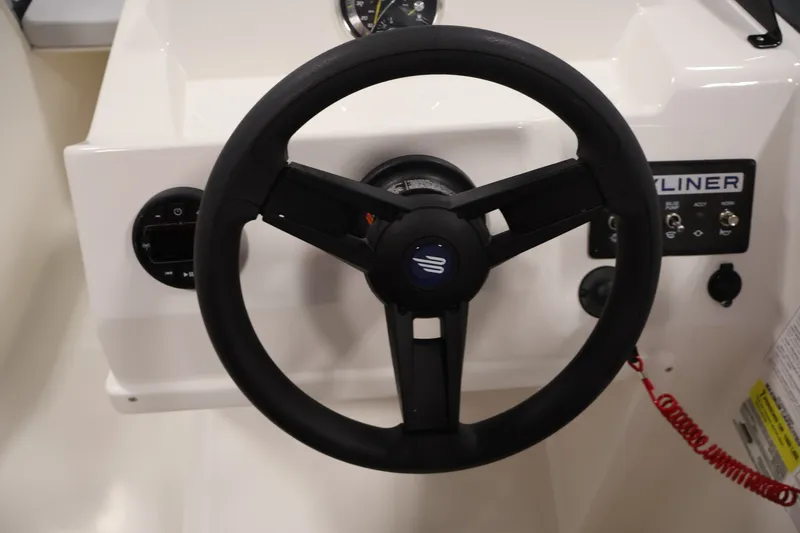 Slide: The Image of Steering wheel of 2026 Bayliner Element M17 boat, featuring dashboard controls. - 14