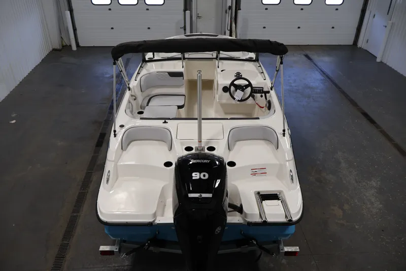 Slide: The Image of 2026 Bayliner Element M17 boat in a garage, featuring a Mercury 90 engine. - 9