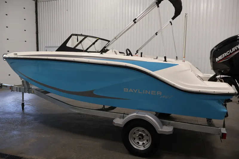 Slide: The Image of 2026 Bayliner Element M17 boat in a showroom, featuring a sleek blue and white design. - 7