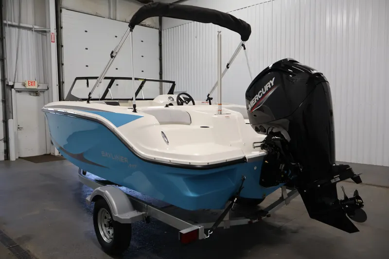 Slide: The Image of 2026 Bayliner Element M17 boat with Mercury outboard motor in a garage setting. - 6