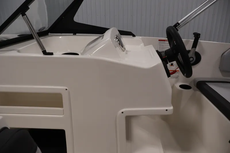 Slide: The Image of 2026 Bayliner Element M17 boat dashboard with steering wheel and controls. - 12