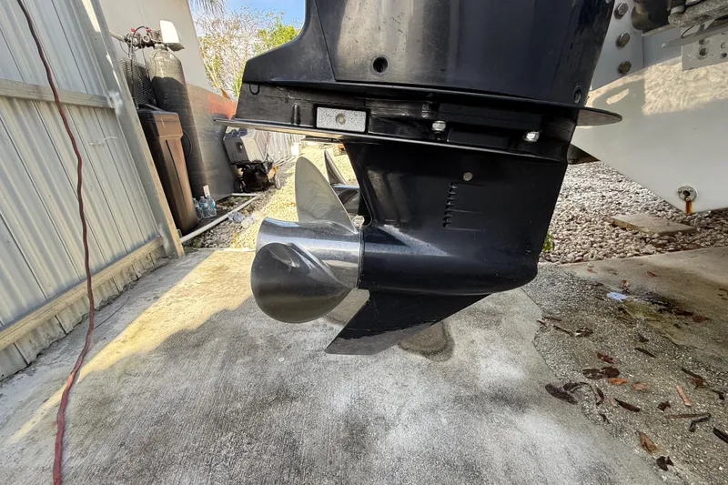 Slide: The Image of Close-up of 1989 Wellcraft 302 Scarab boat propeller in a driveway setting. - 10