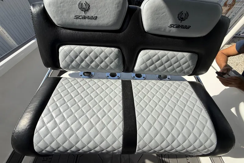 Slide: The Image of 1989 Wellcraft 302 Scarab boat seat with quilted upholstery and Scarab logo. - 103