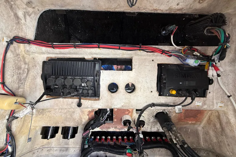 Slide: The Image of Electrical panel of a 1989 Wellcraft 302 Scarab boat with wiring and devices. - 104