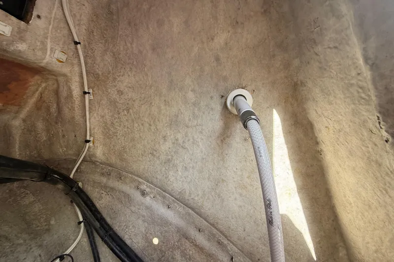 Slide: The Image of Interior view of 1989 Wellcraft 302 Scarab boat showing wiring and hose connections. - 107