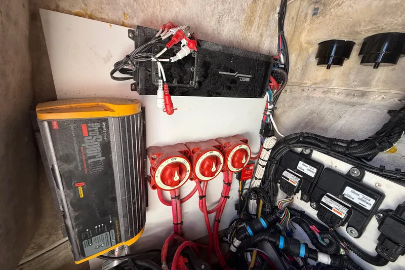 Slide: The Image of Electrical components inside a 1989 Wellcraft 302 Scarab boat, featuring wiring and switches. - 108