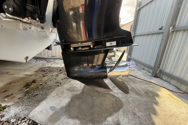 Slide: The Image of 1989 Wellcraft 302 Scarab boat engine propeller in a garage setting. - 11