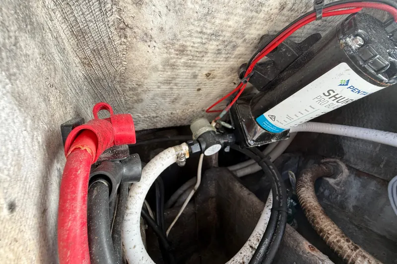 Slide: The Image of Electrical and plumbing components inside a 1989 Wellcraft 302 Scarab boat. - 114