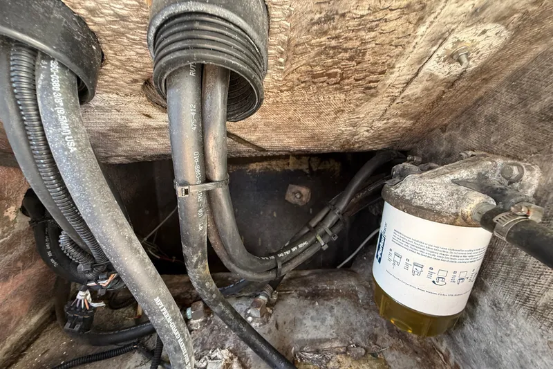 Slide: The Image of Engine compartment of a 1989 Wellcraft 302 Scarab with visible hoses and fuel filter. - 115