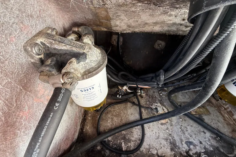 Slide: The Image of 1989 Wellcraft 302 Scarab engine compartment showing fuel filter and wiring. - 116