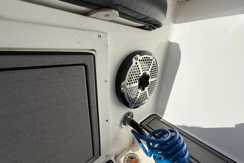 Slide: The Image of 1989 Wellcraft 302 Scarab interior with speaker and coiled blue hose. - 118