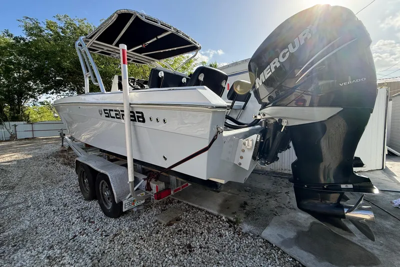 Slide: The Image of 1989 Wellcraft 302 Scarab boat with Mercury Verado engines on a trailer. - 12