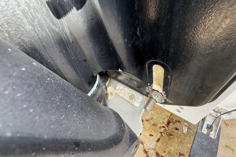 Slide: The Image of Close-up of 1989 Wellcraft 302 Scarab boat component with visible bolt and sealant. - 126