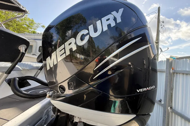 Slide: The Image of Mercury Verado engine on 1989 Wellcraft 302 Scarab boat, docked outdoors. - 13