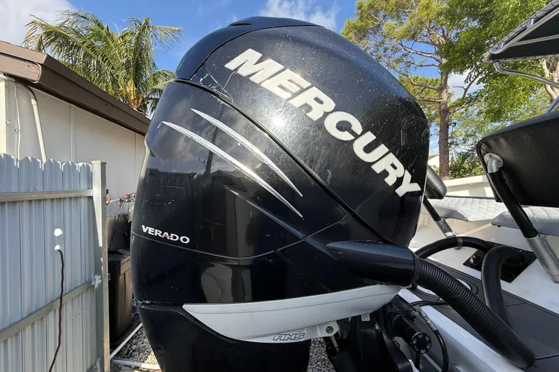 Slide: The Image of Mercury Verado outboard motor on 1989 Wellcraft 302 Scarab boat, outdoor setting. - 14