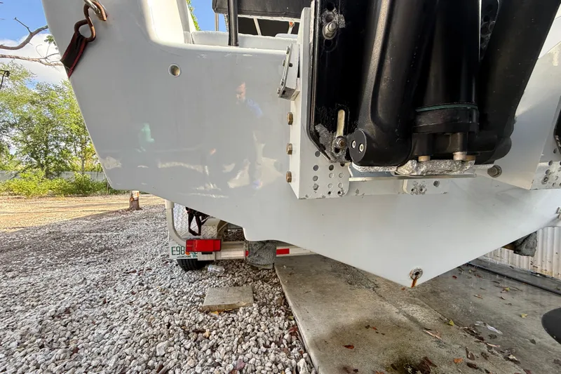 Slide: The Image of 1989 Wellcraft 302 Scarab boat on trailer, showing rear hull and engine mount. - 15