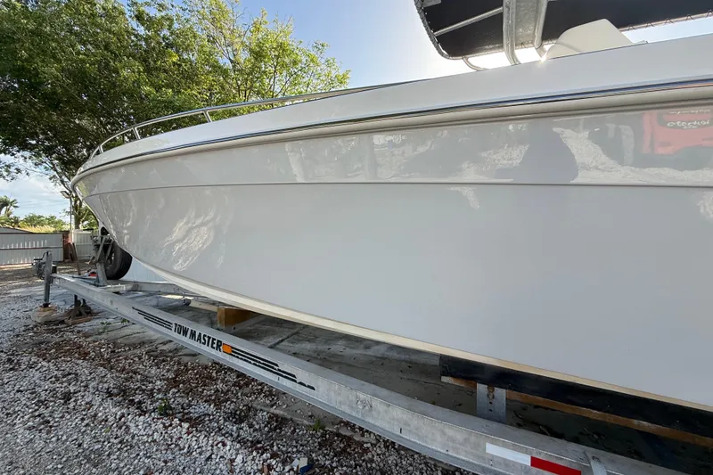 Slide: The Image of 1989 Wellcraft 302 Scarab boat on trailer, side view, outdoors. - 23