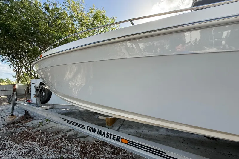 Slide: The Image of 1989 Wellcraft 302 Scarab boat on Tow Master trailer, parked outdoors. - 24