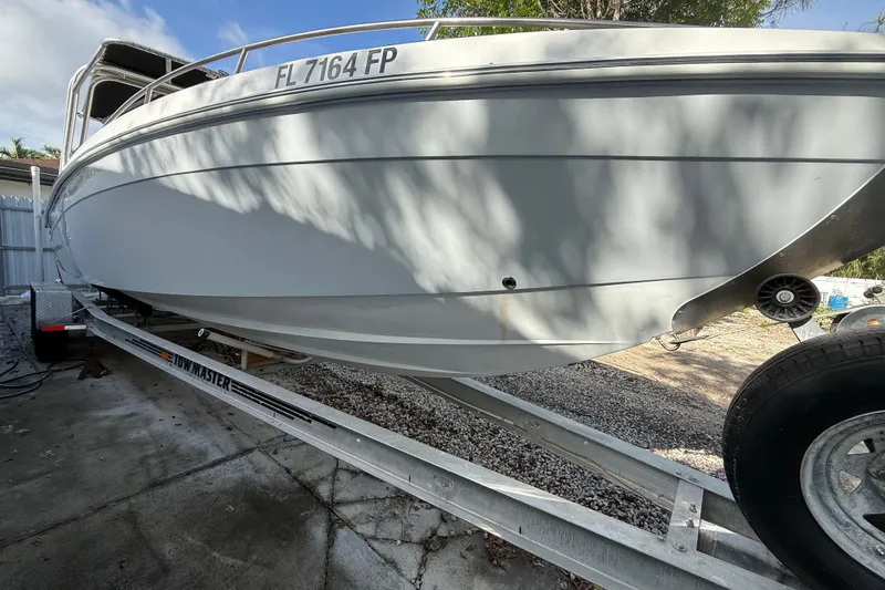 Slide: The Image of 1989 Wellcraft 302 Scarab boat on trailer, side view, with registration number FL 7164 FP. - 31