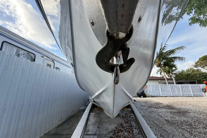 Slide: The Image of 1989 Wellcraft 302 Scarab boat on trailer, close-up view of bow and hook. - 45