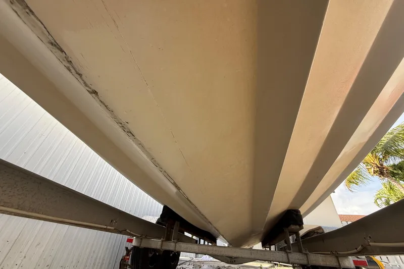 Slide: The Image of 1989 Wellcraft 302 Scarab boat hull on trailer, viewed from below. - 49