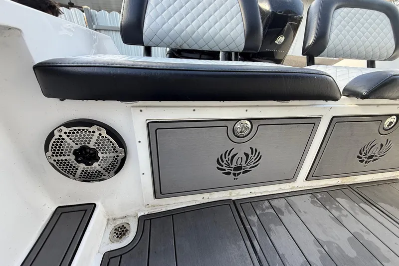 Slide: The Image of Interior of 1989 Wellcraft 302 Scarab boat with cushioned seating and speaker. - 54