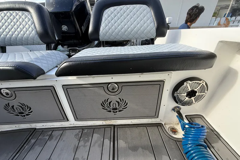 Slide: The Image of 1989 Wellcraft 302 Scarab boat interior with quilted seats and marine speaker. - 55