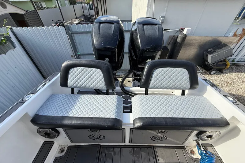 Slide: The Image of 1989 Wellcraft 302 Scarab boat interior with dual seats and twin outboard motors. - 56