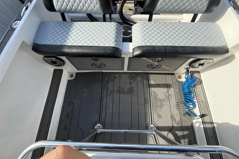 Slide: The Image of Interior of 1989 Wellcraft 302 Scarab boat with cushioned seating and deck details. - 57