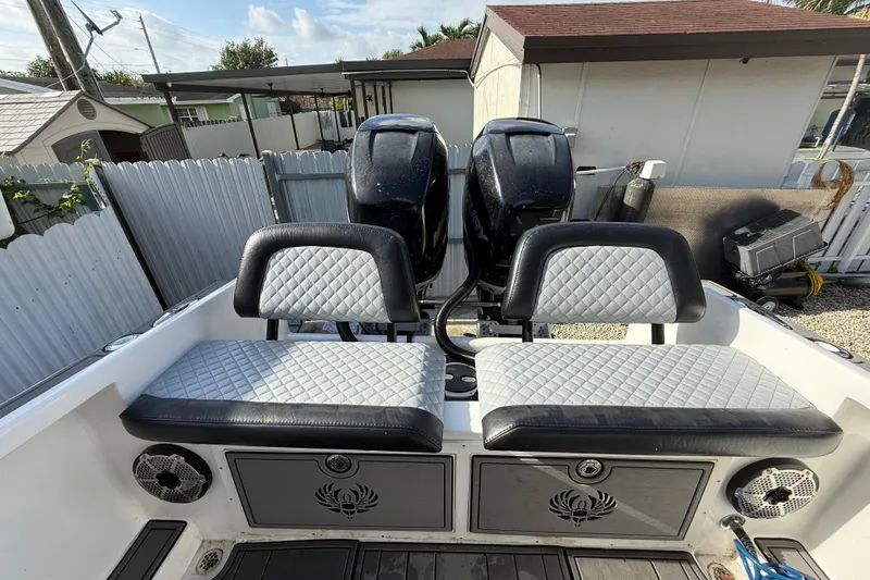 Slide: The Image of 1989 Wellcraft 302 Scarab boat interior with dual seats and twin engines. - 58