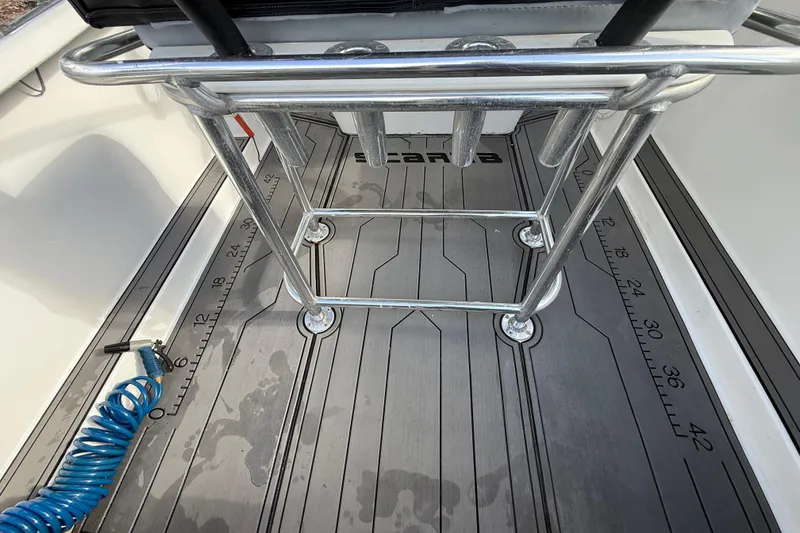 Slide: The Image of 1989 Wellcraft 302 Scarab boat deck with metal railing and measuring scale. - 59