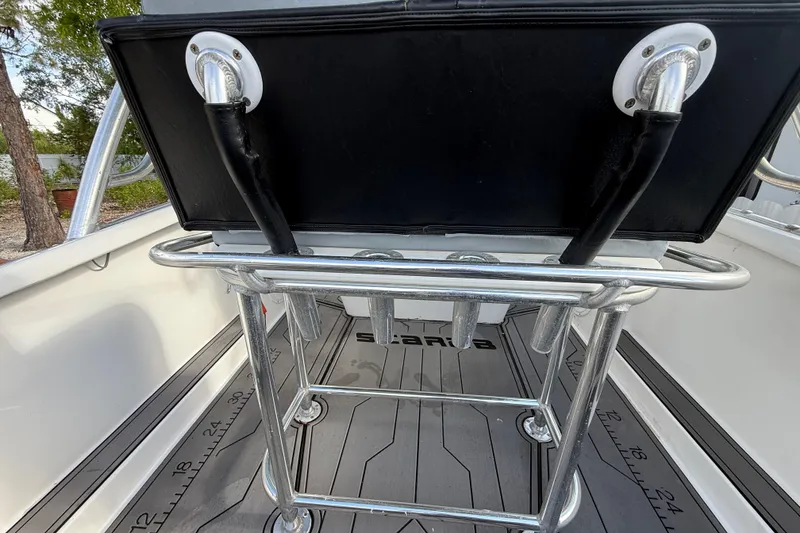 Slide: The Image of 1989 Wellcraft 302 Scarab boat interior with metal railing and black seat. - 60