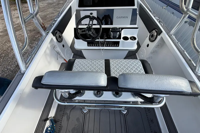 Slide: The Image of 1989 Wellcraft 302 Scarab boat cockpit with Garmin navigation system and cushioned seating. - 62