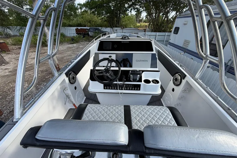 Slide: The Image of 1989 Wellcraft 302 Scarab boat cockpit with Garmin navigation system and silver seating. - 63