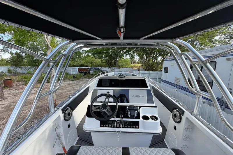 Slide: The Image of 1989 Wellcraft 302 Scarab boat cockpit with Garmin navigation system and steering wheel. - 64