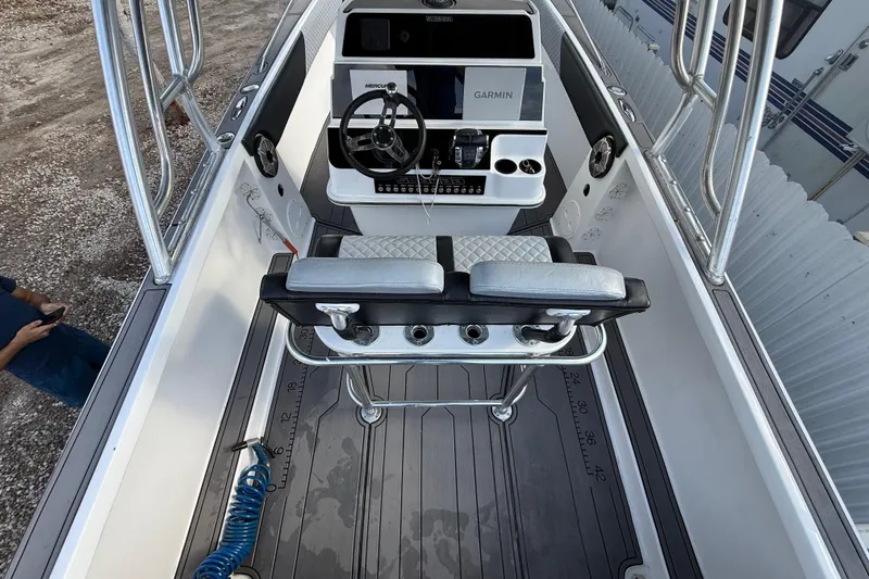 Slide: The Image of 1989 Wellcraft 302 Scarab boat cockpit with steering wheel, Garmin display, and seating. - 67