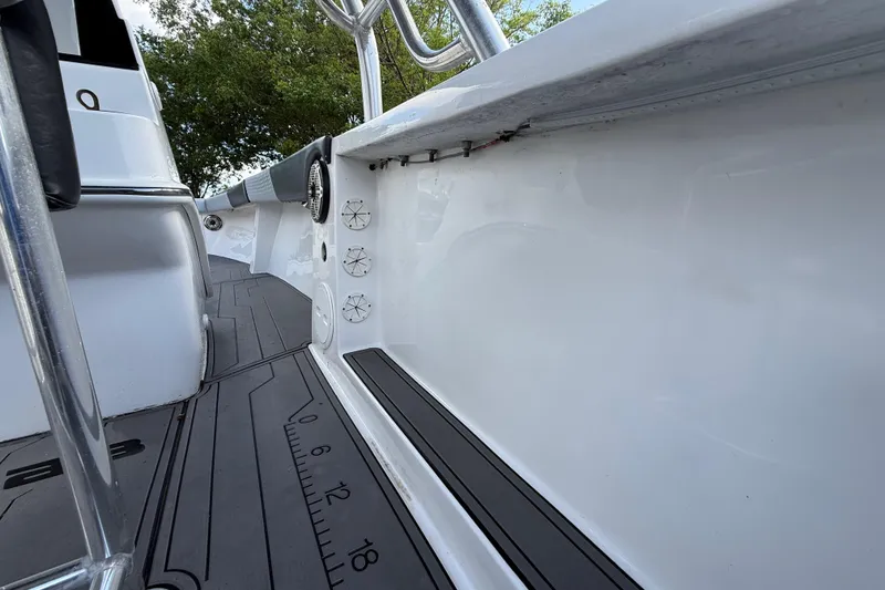 Slide: The Image of 1989 Wellcraft 302 Scarab boat interior with sleek white design and measurement markings. - 69