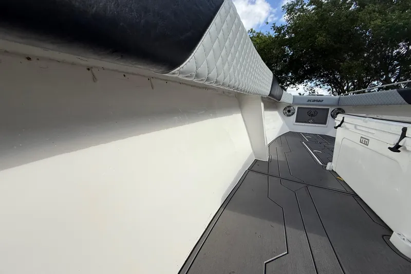 Slide: The Image of 1989 Wellcraft 302 Scarab boat interior with cushioned seating and modern flooring. - 78