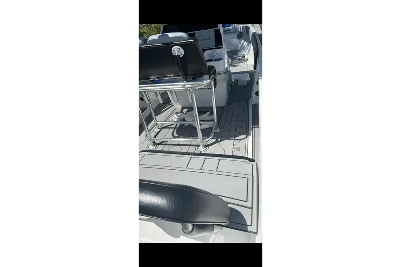 Slide: The Image of 1989 Wellcraft 302 Scarab with Mercury Verado outboard motor in a driveway setting. - 8