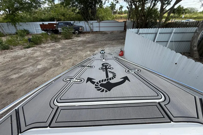 Slide: The Image of 1989 Wellcraft 302 Scarab boat deck with anchor design, parked outdoors. - 82