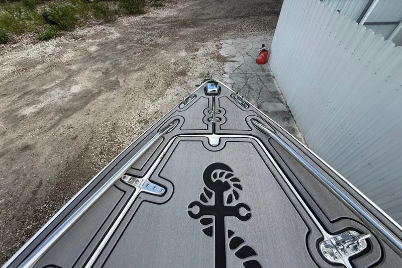 Slide: The Image of 1989 Wellcraft 302 Scarab boat deck with custom design, parked on gravel. - 83