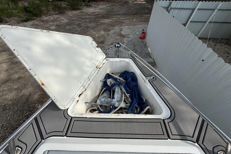 Slide: The Image of Open storage compartment on 1989 Wellcraft 302 Scarab boat, containing ropes and anchor. - 84