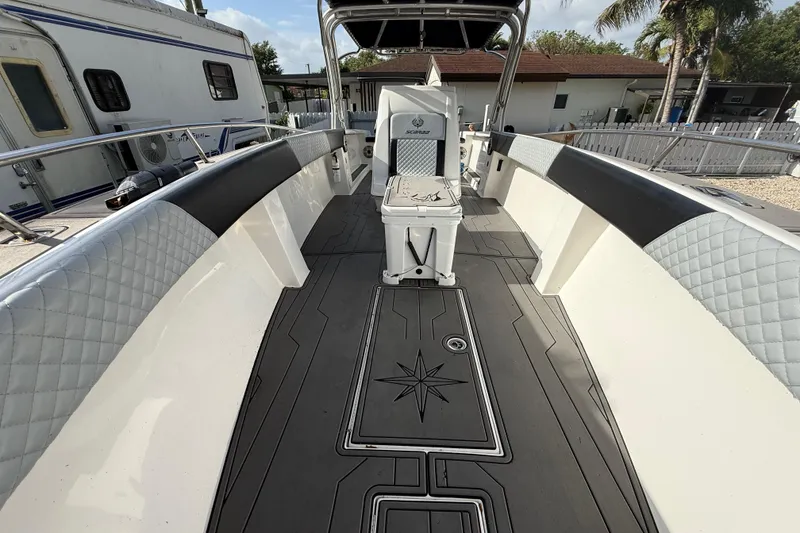 Slide: The Image of 1989 Wellcraft 302 Scarab boat interior with cushioned seating and stylish flooring. - 87