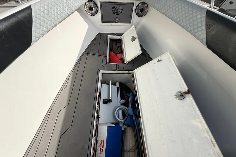 Slide: The Image of 1989 Wellcraft 302 Scarab boat interior with open storage compartments and modern upholstery. - 89