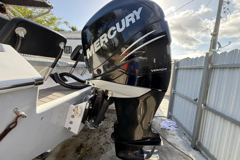 Slide: The Image of 1989 Wellcraft 302 Scarab with Mercury Verado outboard motor in a sunny outdoor setting. - 9