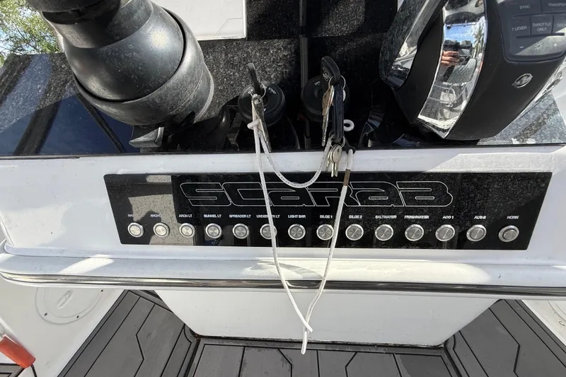 Slide: The Image of Control panel of a 1989 Wellcraft 302 Scarab boat with keys and switches. - 94